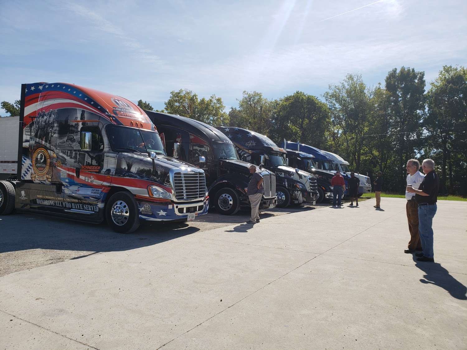 Row of trucking carriers parked in a gravel yard