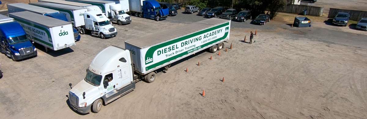 Image of aerial shot of DDA truck and trailer on training yard in front of truck driver job placement carrier partner tractors