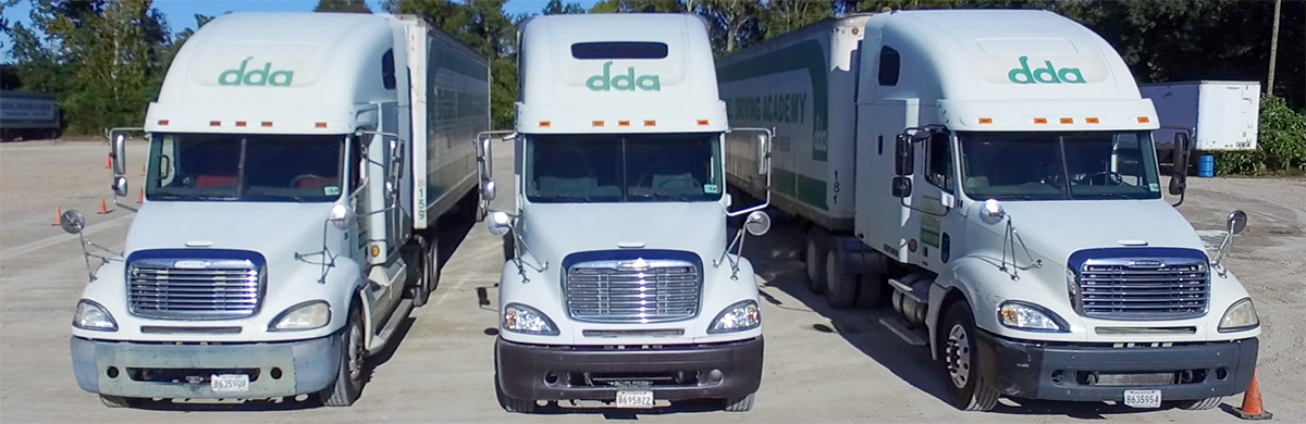 Image of three DDA trucks on Class A CDL driver training yard