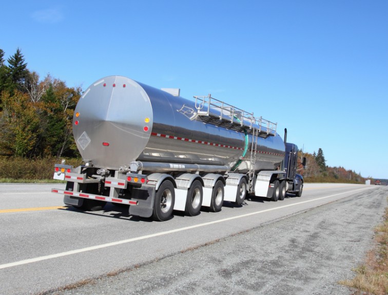 Backside of hazmat tanker semi truck on an open road