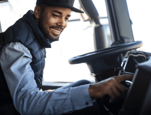 Image of driver sitting behind the wheel listening to trucker songs